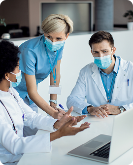 group-medical-experts-talking-while-using-laptop-meeting-hospital 1 (1)