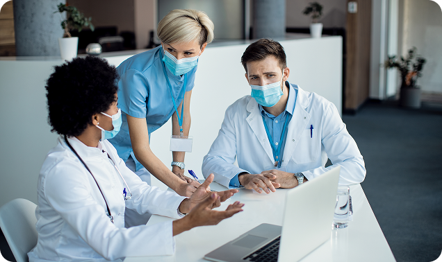 group-medical-experts-talking-while-using-laptop-meeting-hospital 2